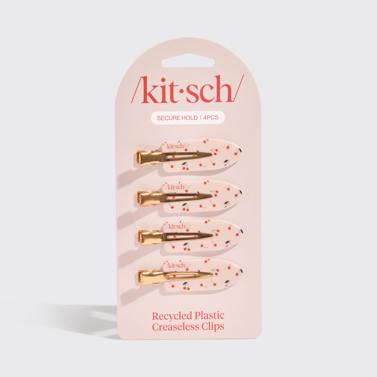 Kitsch Cherry Print Creaseless Clips 4pc Set displayed in retail packaging on a gray background.