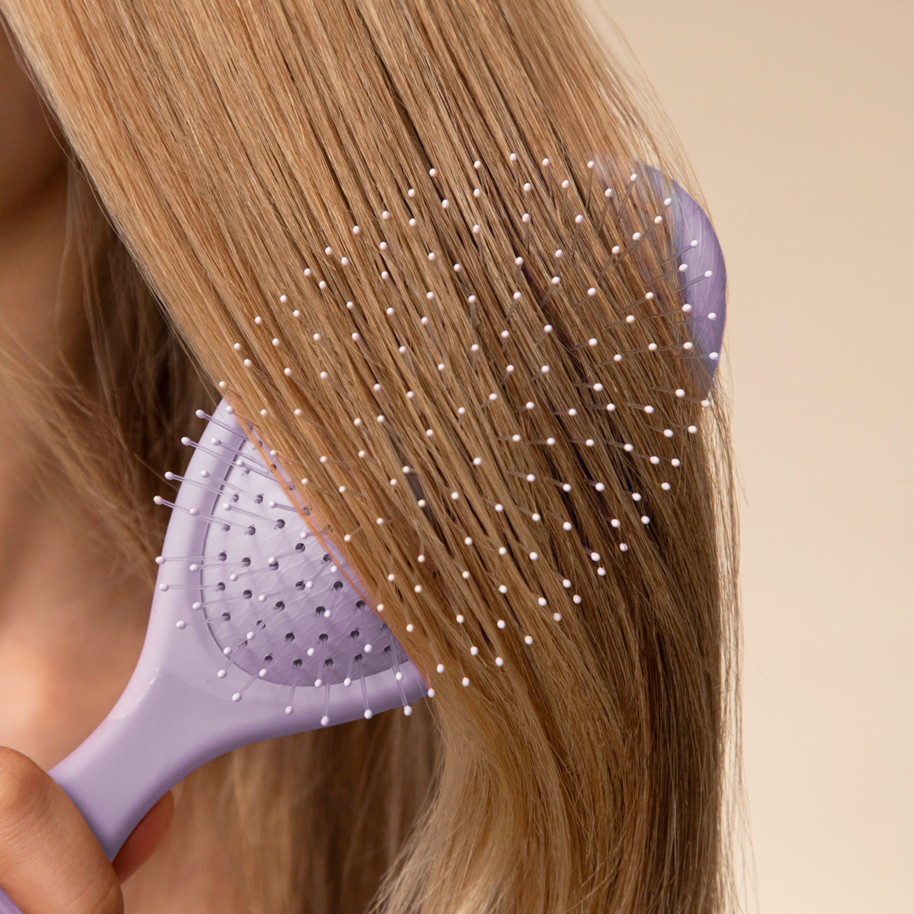 KITSCH Anti-Shedding Hair Essentials Bundle — lifestyle — model using Soft Violet Wet/Dry Brush on dry hair — flexible bristles glide through tangles to minimize breakage