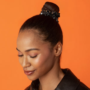 KITSCH Ghosts & Pumpkins Ruched Satin Scrunchies 5pc Set — lifestyle model shot styling hair with a pumpkin print scrunchie — satin won't snag or pull strands