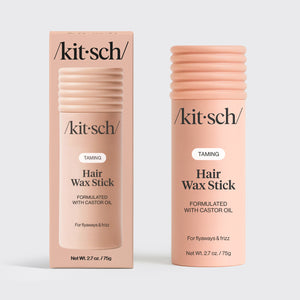 KITSCH Hair Wax Stick — hero product shot on light gray background — two TAMING Hair Wax Stick Formulated With Castor Oil — one with retail box packaging, one standalone stick — For flyaways & frizz — Net Wt. 2.7 oz / 75g — 100% vegan & plant-based wax enriched with nourishing castor oil — All-day hold without texture or greasiness